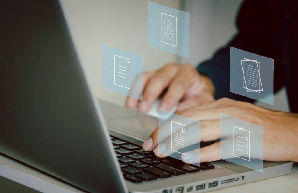 A man typing on a laptop to create an outline for his blog post. Keep reading for tips on how to write blog posts faster.