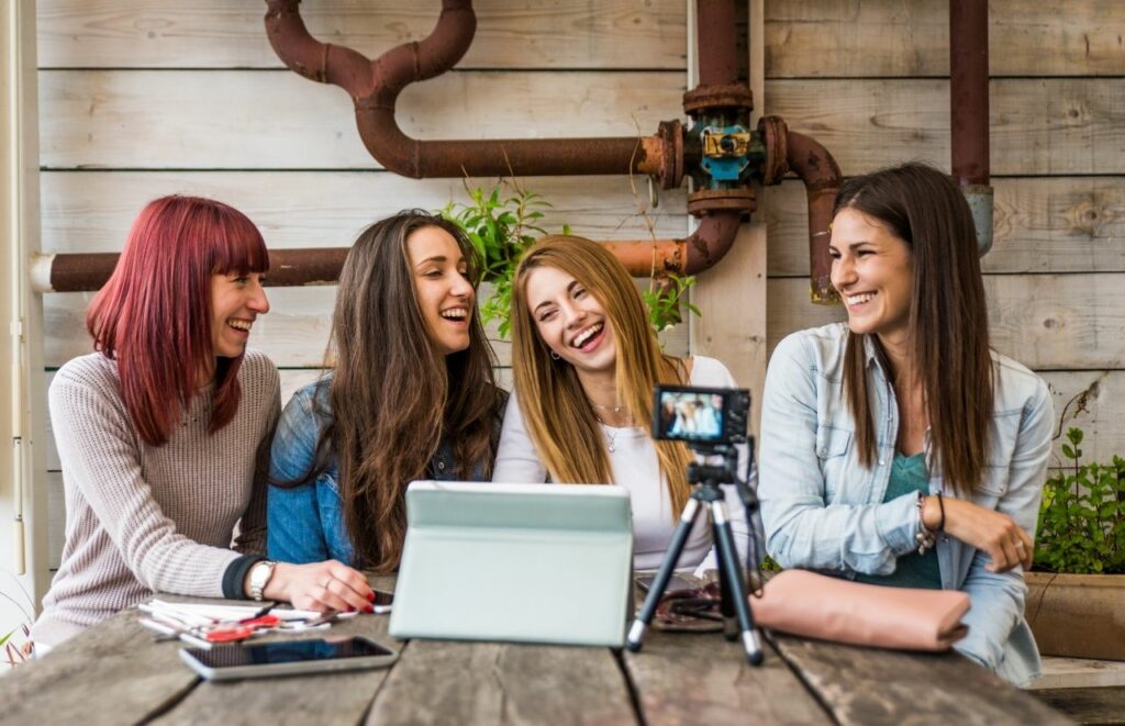 Group of ladies taking photos to put on their blog to help build backlinks