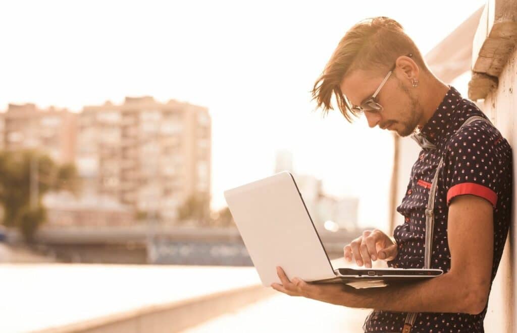 Hipster man writing blog post