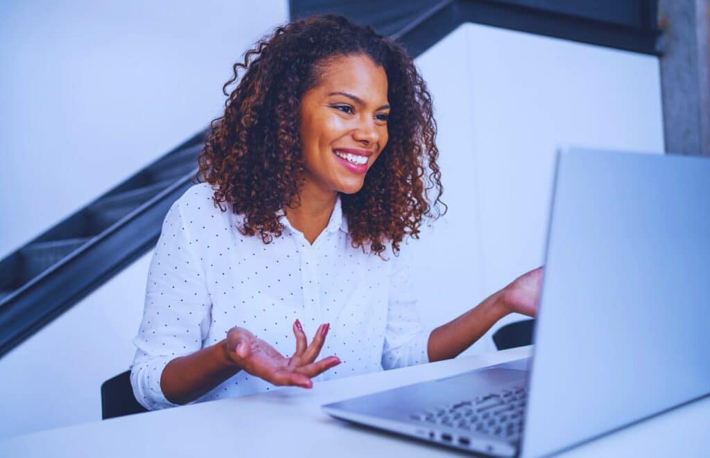 Black woman Blog Writer looking at computer. Keep reading to learn about creating an Editorial Content Strategy and content marketing.