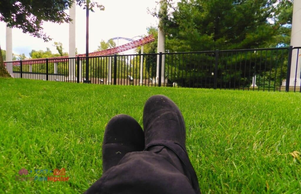 Cedar Point NikkyJ on grassy lawn next to Top Thrill Dragster. Keep reading to learn how this theme park blogger and Disney blogger makes money.