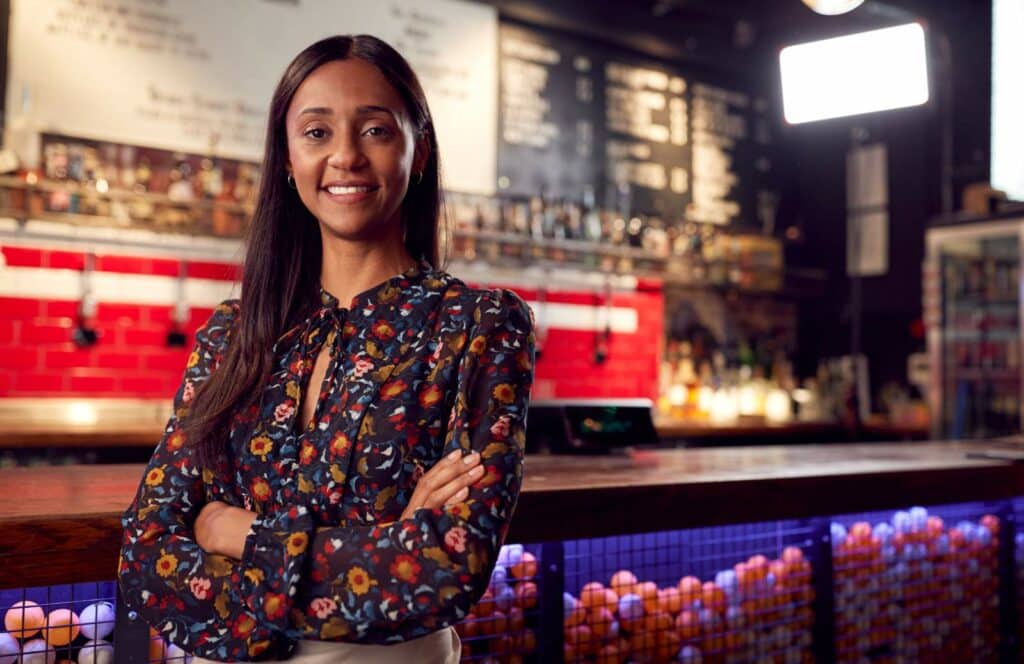 A confident woman at an event that was sponsored by a local company brand through her blog. Keep reading to learn more about the future of blogging and how to monetize your blog from day one