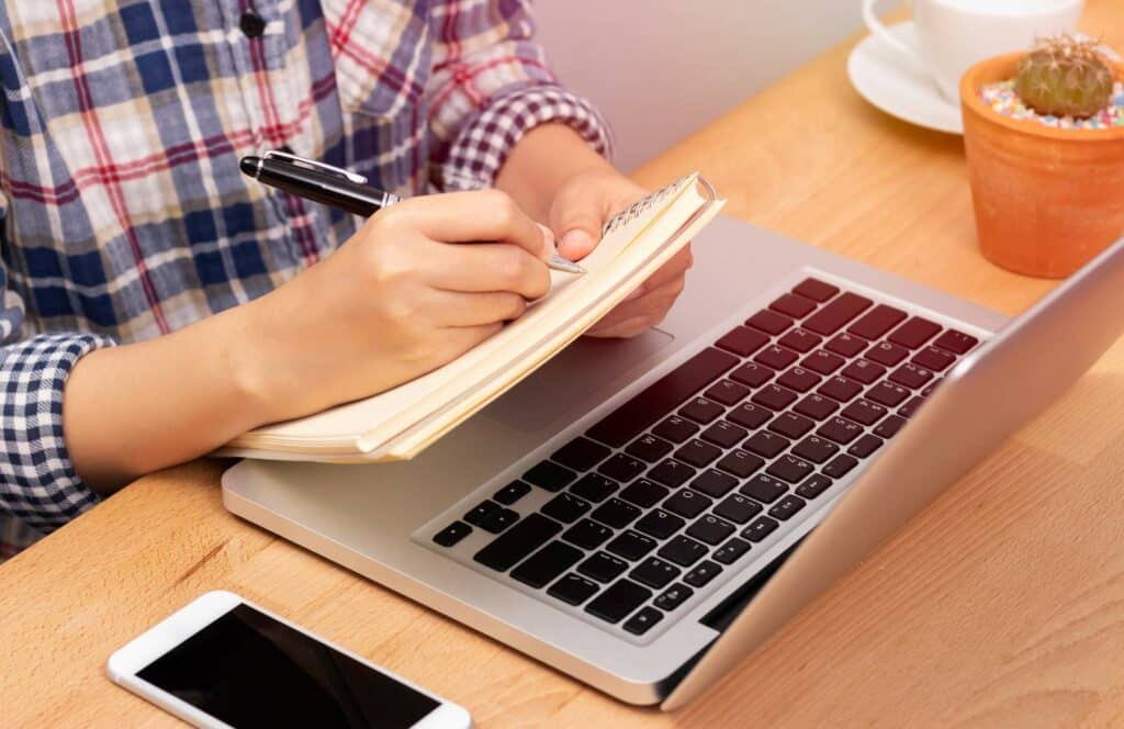 A man preparing the outline for a course as he is learning to monetize his blog from day one. Keep reading to learn how to make money blogging.