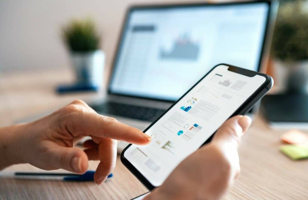 A man scrolling his mobile phone after downloading a digital finance tracker from a finance blogger. Keep reading to learn more about how you can increase website conversions.