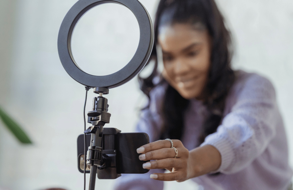 A Black woman who is confident in front of the camera and vlogs for YouTube. Keep reading to learn the answer to the question, "Is Blogging Still Relevant?"