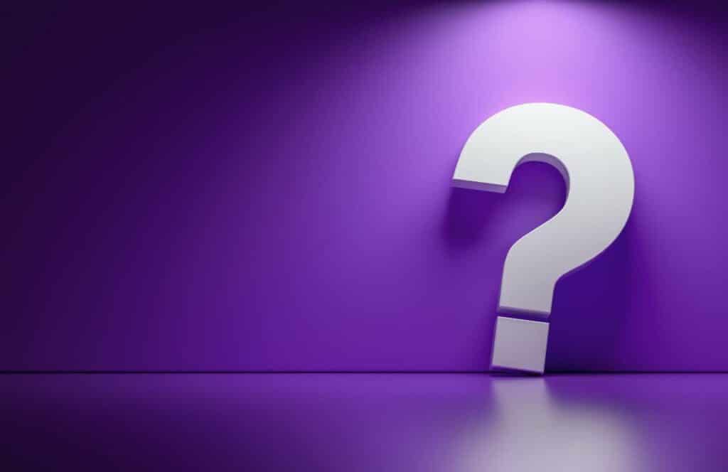 A large question mark on the left side of a purple wall background representing questions that are being asking about how to increase conversion rate on website. Keep reading to learn more about how you can increase website conversions.