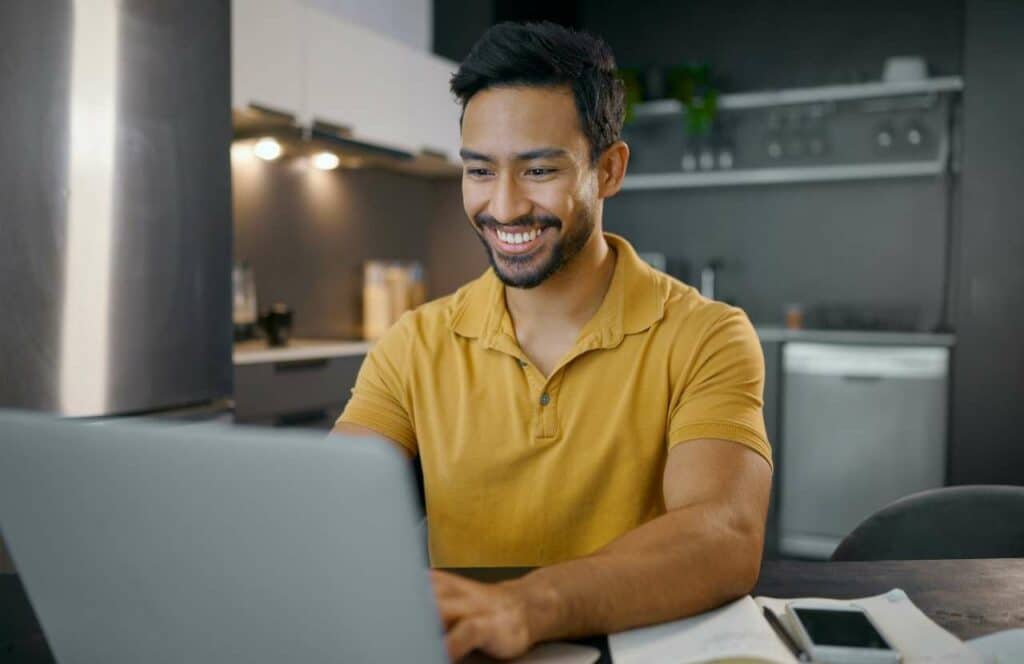 A man sitting in a home office writing copy for his blog.