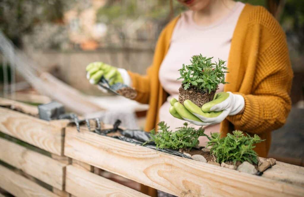 A woman doing gardening while creating content for her blog. If you have ever asked "What's the point of blogging?" click here to read more.