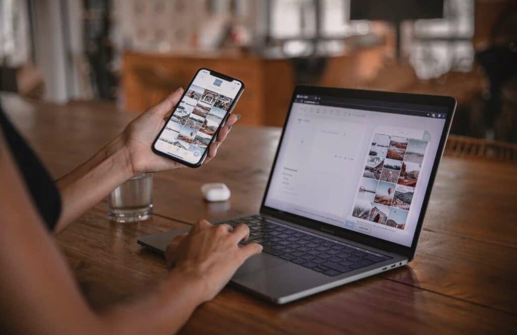 A woman uploading images from her phone to her laptop to insert in her blog post. Keep reading to learn more about how you can increase website conversions.