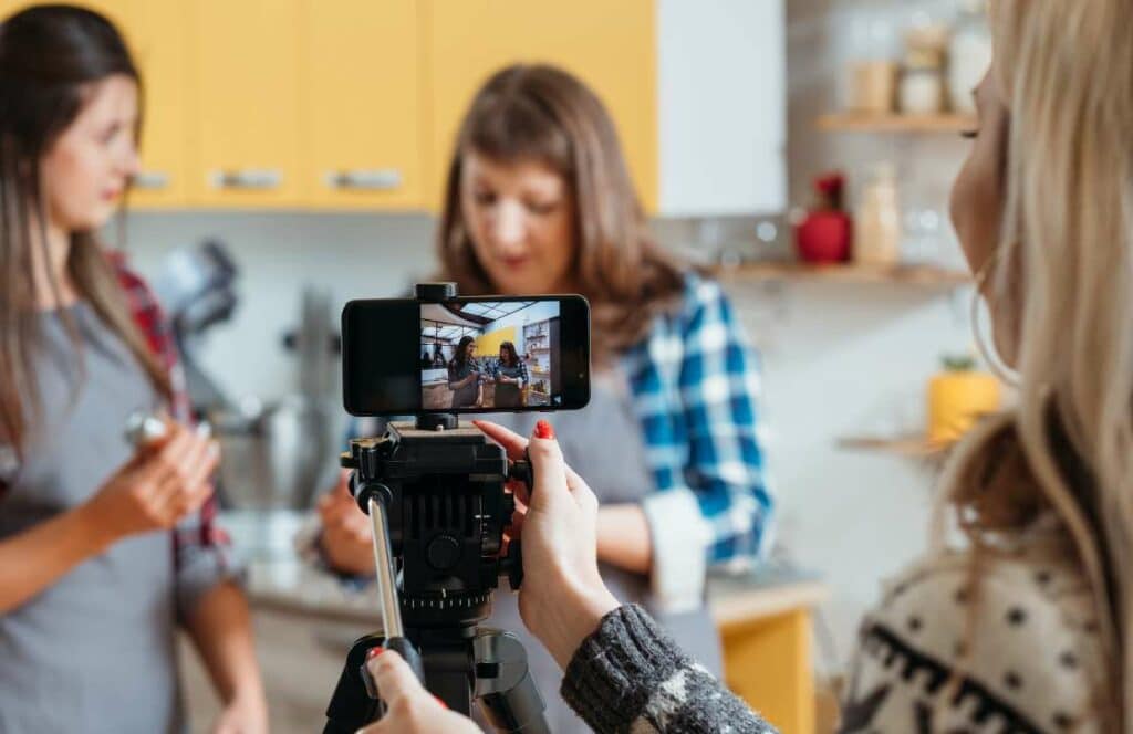 Three women getting frustrated as they are trying to film social media content for their blog. If you've ever wondered What's the point of blogging click here to read more.