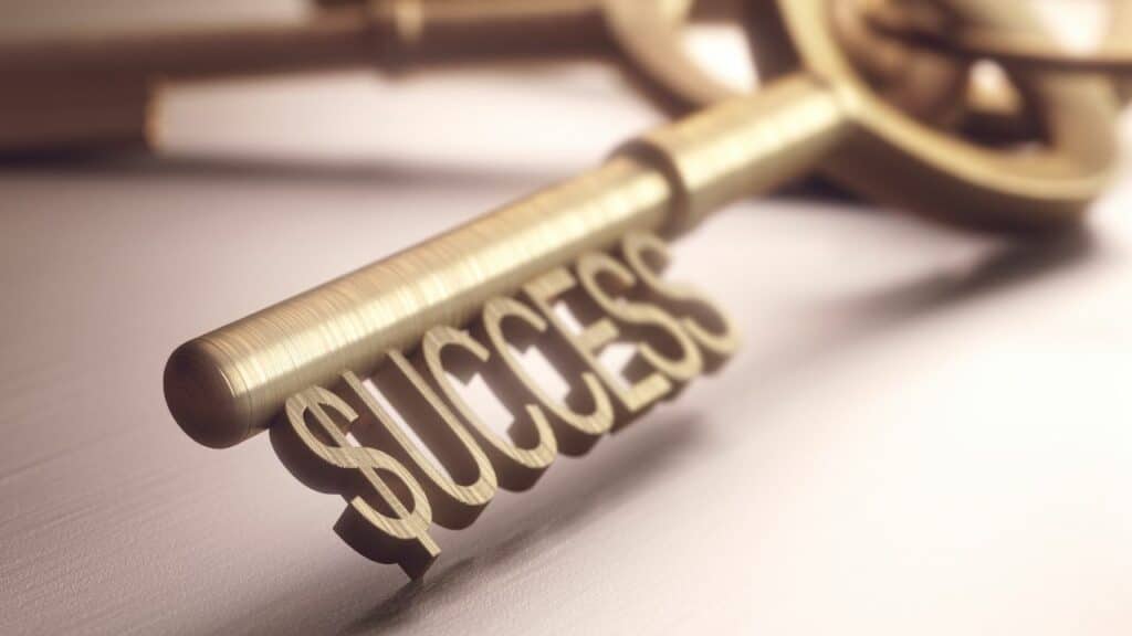 Key to success - a shiny silver key on a metallic surface, symbolizing the path to achieving success. Keep reading to learn about the best insurance affiliate marketing programs available for bloggers and content marketers.